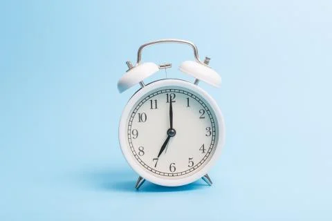 Alarm clock on blue background Stock Photos