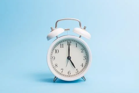Alarm clock on blue background Stock Photos