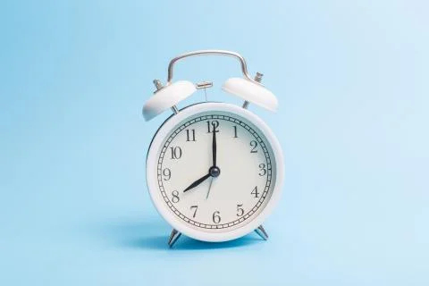 Alarm clock on blue background Stock Photos