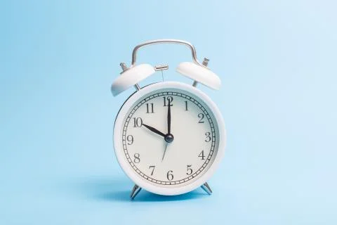 Alarm clock on blue background Stock Photos