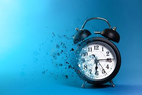 Alarm clock on blue background. Time concept. Close up. Stock Photos
