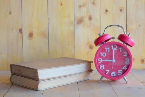 Alarm clock, book Stock Photos