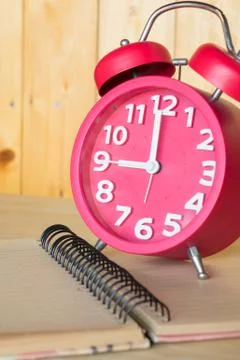 Alarm clock, on a book Stock Photos