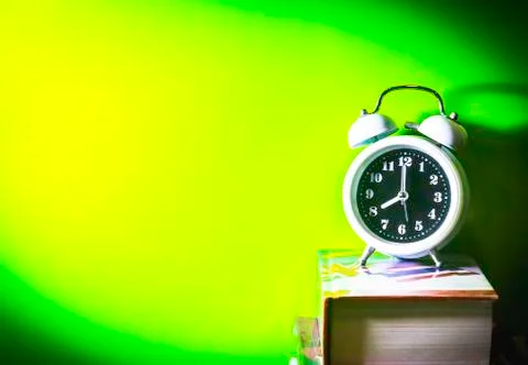 Alarm clock with book Stock Photos