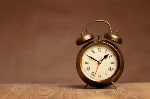Alarm Clock on brown background Stock Photos