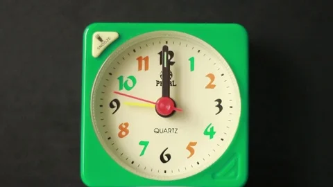 Alarm clock close to Twelve Stock Footage 76039549
