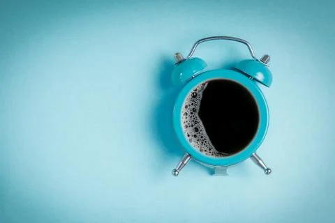 Alarm clock with coffee cup inside Stock Photos