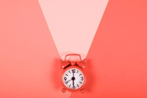 Alarm clock on colored background. Stock Photos