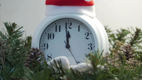 Alarm clock counting down to midnight for New Year. Metal Christmas tree between Stock Footage 165767405