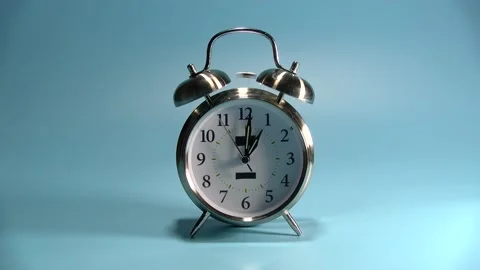 Alarm clock dual bell ringing time to wake up isolate it on blue Video stock 218412539