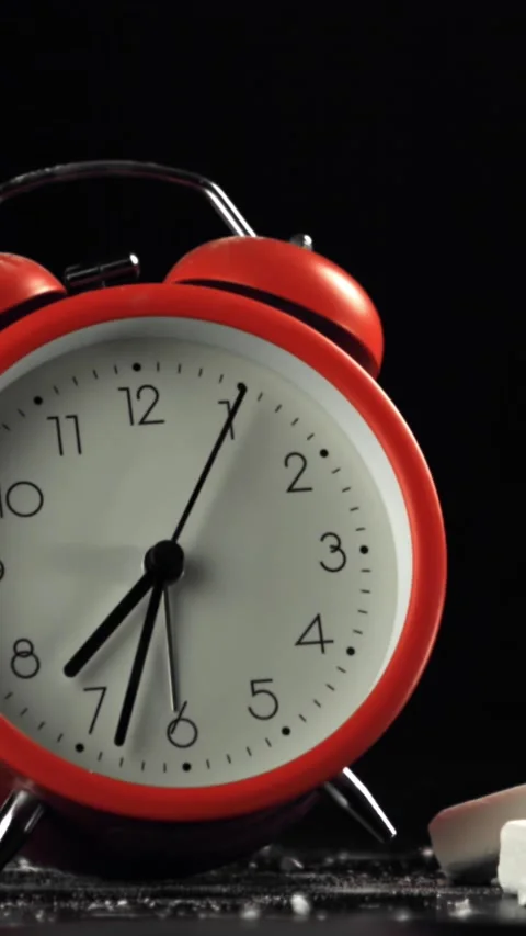 The alarm clock falls on the school desk. Filmed on a high-speed camera at 1000 Stock Footage 335371911