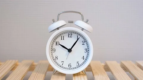 Alarm clock on gray background close-up, concept of time management. Stock Footage 181940126