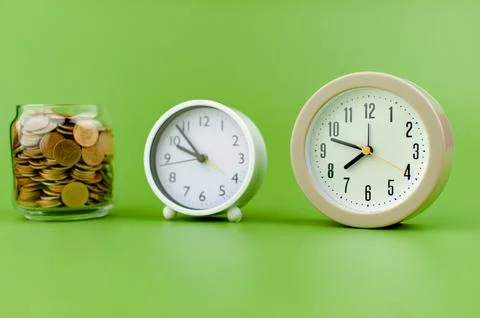 Alarm clock on green background time concept working with time precious time Stock Photos