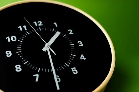 Alarm clock on green background time concept working with time precious time Stock Photos