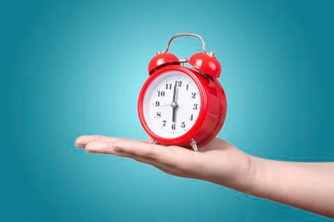 Alarm clock on hand Stock Photos