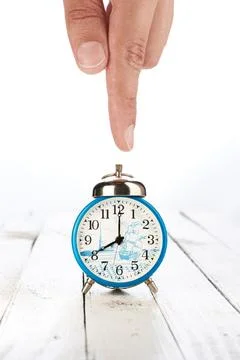 Alarm clock with hand Stock Photos