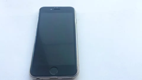 The alarm clock in the iPhone ringing at 7 a.m and the man turns off the alarm Stock Footage 172412646