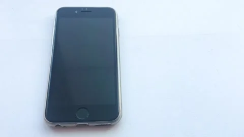 The alarm clock in the iPhone rings at 7 a.m and the man turns off the alarm Stock Footage 172412198