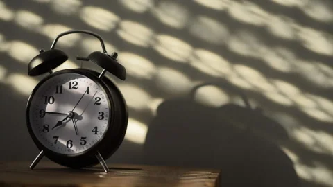 Alarm clock on night table in bedroom Stock Footage 86597196
