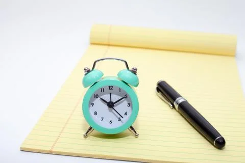 Alarm clock, notes and pen Stock Photos