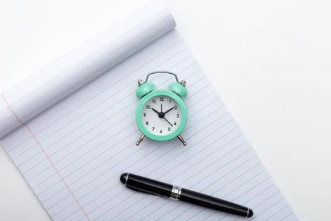 Alarm clock, notes and pen Stock Photos