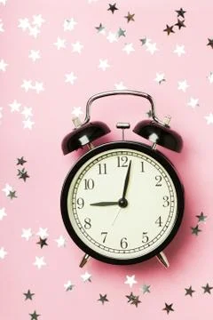 Alarm clock on the pink background Stock Photos