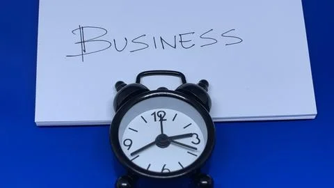 Alarm clock positioned below the word Business, Stock Photos