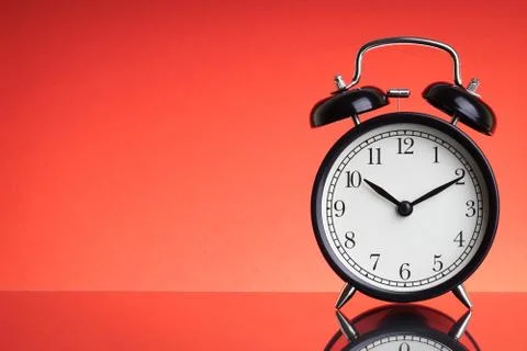 Alarm Clock on red background with selective focus 库存照片