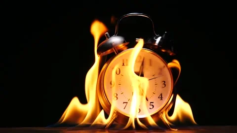 Alarm clock ring covered in flames burning and melting and slow motion Stock Footage 231745977