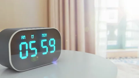 Alarm clock ringing at 6 am morning in the hotel's room and sun is shining Stock Footage 161302910