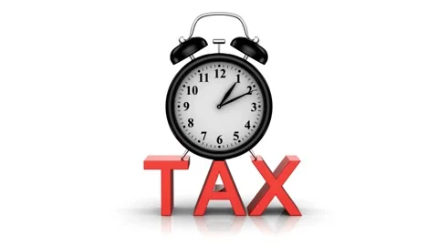 Alarm clock ringing on red tax text for tax time concept Stock Footage 336400755