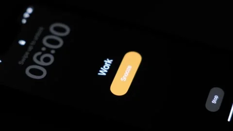 Alarm clock ringing on a smartphone with a reminder to go to work at 6 o'clock Stock Footage 256167106