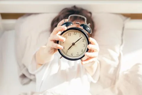 Alarm clock shows time to get up in the morning Stock Photos
