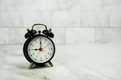 Alarm clock with space for copy on marble background Stock Photos