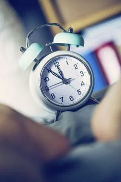 Alarm clock is standing on the bed, close up picture Foto stock