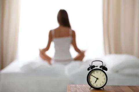 Alarm clock standing on bedside table has already rung early morning to wake up Stock-Fotos