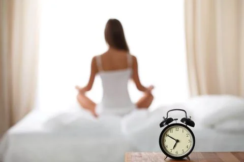 Alarm clock standing on bedside table has already rung early morning to wake up Stock-Fotos