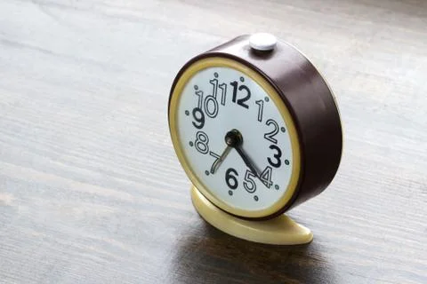 Alarm clock standing on the table Stock Photos