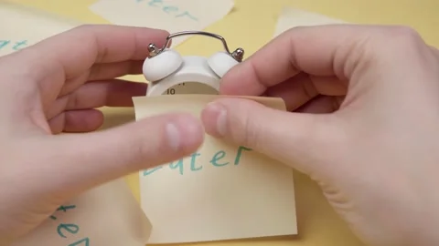 Alarm clock with a sticky note with text later. Procrastination, delay and Video stock 149723301