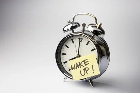 Alarm clock with sticky paper note on white background.. Stock Photos