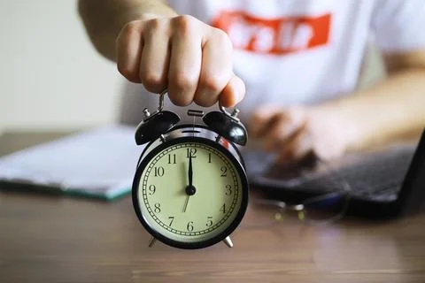 Alarm clock on the table. Time concept. Being late for work and school. Stock Photos