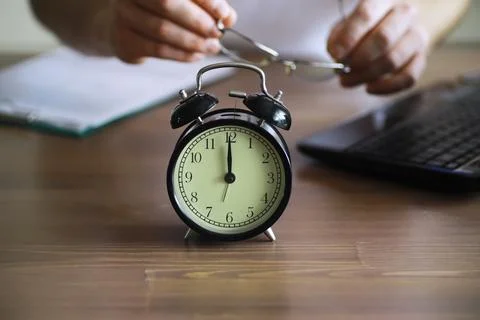 Alarm clock on the table. Time concept. Being late for work and school. Stock Photos