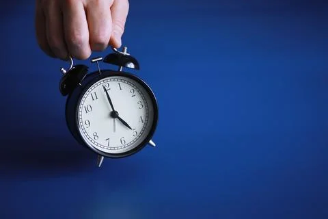 Alarm clock on the table. Time concept. Being late for work and school. Stock Photos
