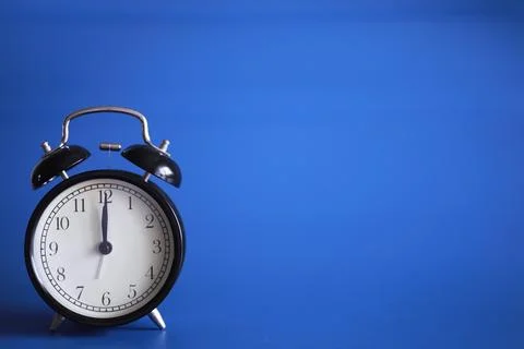 Alarm clock on the table. Time concept. Being late for work and school. Stock Photos