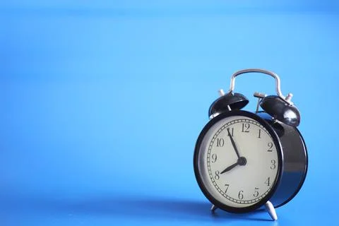 Alarm clock on the table. Time concept. Being late for work and school. Stock Photos