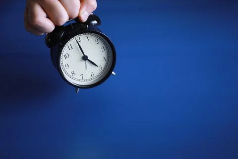 Alarm clock on the table. Time concept. Being late for work and school. Stock Photos