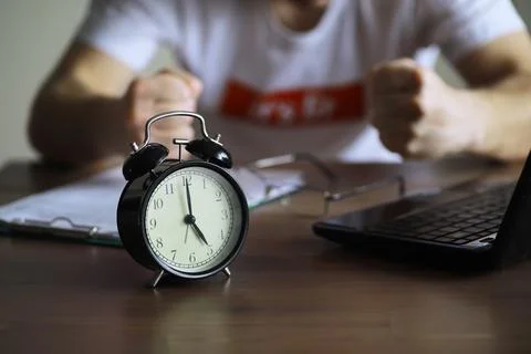 Alarm clock on the table. Time concept. Being late for work and school. Stock Photos