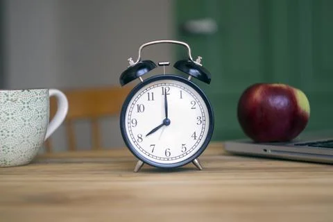 Alarm clock on the table. Time management and morning concept Stock Photos