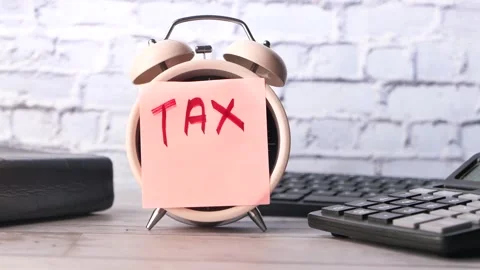 Alarm clock with tax note reminds about deadline. Stock Footage 333258718