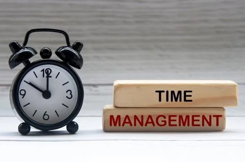 Alarm clock with text Time Management on wooden blocks. 스톡 사진